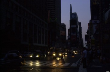 Times Square is plunged into darkness as the sun goes down a